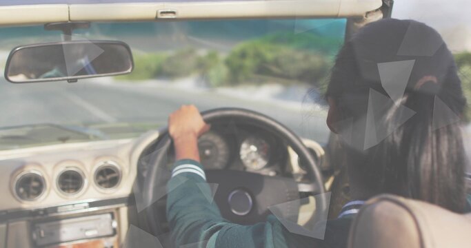 Driving female driver in green jacket holding steering wheel on road, dashboard visible, copy space