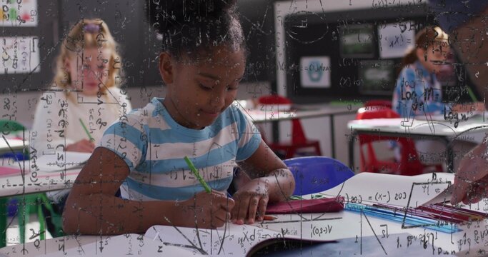 Writing girl in blue-striped shirt leaning at desk at school, using green pencil on workbook