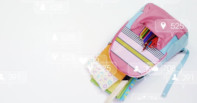 Showing pastel backpack holding ABC supplies, notebook on white table with social pins, copy space