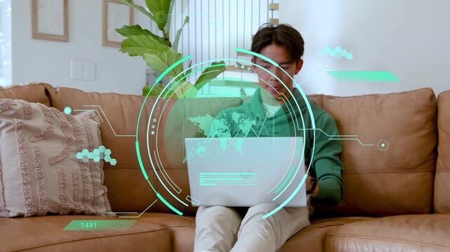 Adult man adjusting laptop, typing, analyzing tech data at home with teal HUD showing charts, map