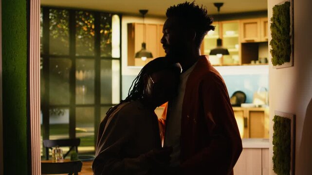 Happy black couple after argument sharing intimacy and comfort indoors, holding each other close. Man and woman reconnect through gentle caress and empathy, illustrating reconciliation success.