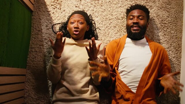 Top down view, african american couple, fighting on the floor, rage and frustration, furious partners struggling with relationship quarrel and unhappy emotions. Domestic life with drama and bad mood.