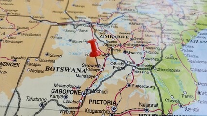Naklejka premium View of Serowe, is an urban village in Botswana's Central District, on a geographical map of Africa, marked with red push pin