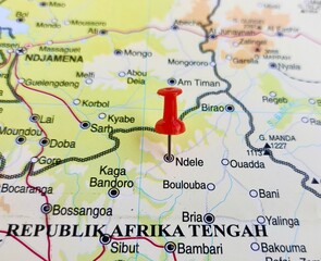 View of N'Dele or Ndele, is a market town and sub prefecture in the north eastern Central African Republic, on a geographical map of Africa, marked with red push pin © PinkyEn