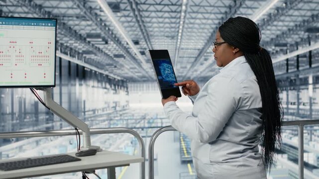 Woman optimizes microchip smart factory workflow with coworker, using EDA software. Teamworking colleagues using simulation tool tracking semiconductor production circuit layout defects, camera B