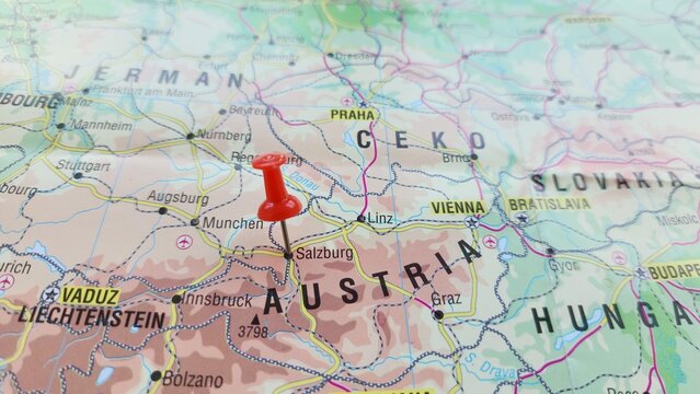 View of Salzburg, is the fourth-largest city in Austria, on a geographical map of Europe, marked with red push pin