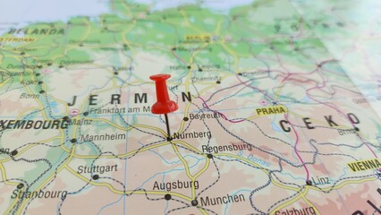 Naklejka premium View of Nuremberg, is the largest city in Franconia and the second-largest city in the German state of Bavaria, on a geographical map of Europe, marked with red push pin
