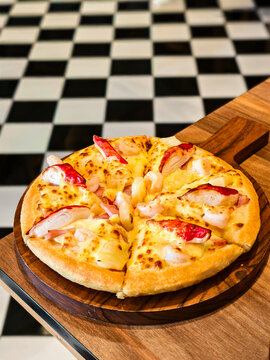 Close up of tropical seafood pizza served in a retro diner setting.