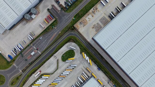 Aerial view of Appleby Magna Industrial Park with rows of parked semi-trucks and large warehouses under soft daylight in Appleby Magna, England, United Kingdom.