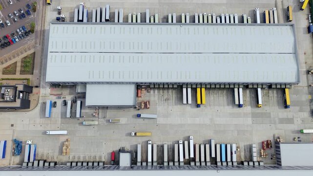 Aerial view of Appleby Magna Industrial Park featuring a large warehouse and numerous semi-truck trailers parked at loading docks in Appleby Magna, England, United Kingdom.