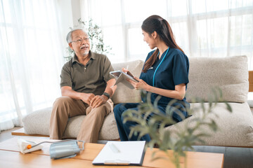 Fototapeta premium Elderly health insurance, elderly man nurse consultation living room patient healthcare care sofa home assessment