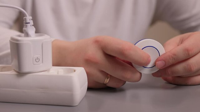 Smart plug handson setup. User demonstrates quick smart socket operation. Individual showcases effortless installation and immediate control of smart electrical devices