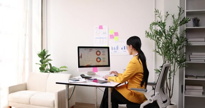 Business asian woman Reviewing Documents, business woman's hands meticulously reviewing a stack of documents, highlighting the details and precision of her work.