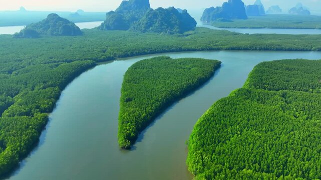 Aerial drone view of heart-shaped mangrove island and winding river highlights coastal biodiversity, limestone scenery, eco-tourism, and wetland conservation. Samet Nangshe, Phang Nga, Thailand. 4k.
