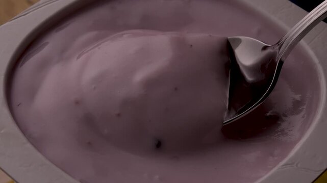 yogurt berries spoon stirring creamy texture closeup food photography healthy breakfast product shot organic fruits motion mix