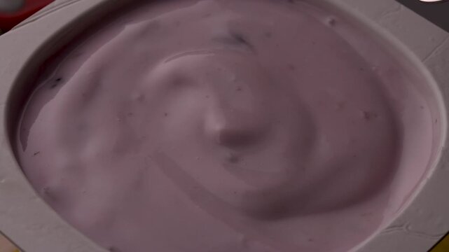 yogurt berries spoon stirring creamy texture closeup food photography healthy breakfast product shot organic fruits motion mix