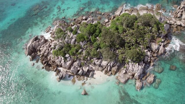 Pull up reveal drone of cocos island, untouched nature, granite stones, clear turquoise water, Seychelles 007 30fps