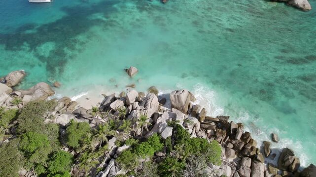 Bird eye view drone of cocos island, lush untouched nature, white sand, granite stones, clear turquoise water, Seychelles 005 30fps