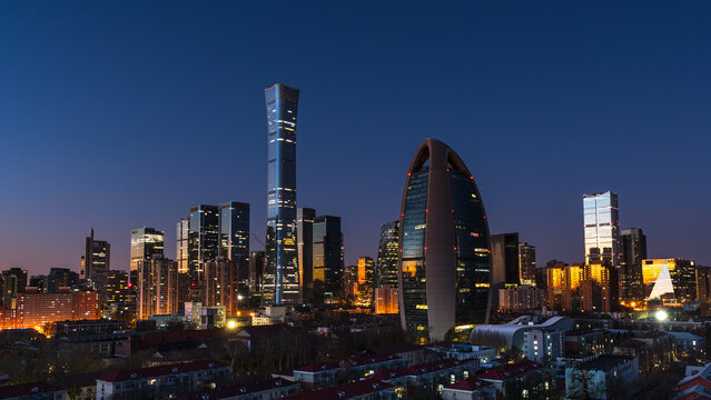 Morning blue hour over the Beijing CBD skyline featuring CITIC Tower (China Zun) and People's Daily Building, showcasing modern urban development