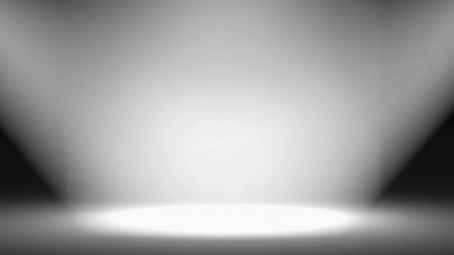 Soft stage spotlight illuminating empty gray studio floor with soft gradient background on stage