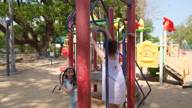 Young Thai Girl Playing on Monkey Bars at Lumpini Park Playground