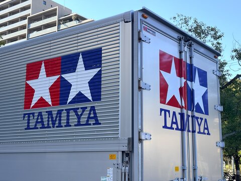 Tamiya Inc logistics delivery truck featuring famous twin star logo and corporate branding displayed on silver corrugated cargo trailer - Shizuoka, Japan, November 12, 2024