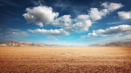 Fototapeta premium Expansive Desert Landscape Under a Dramatic Sky with Fluffy Clouds and Dry Earth, Captivating Nature Scene for Travel and Adventure Themes