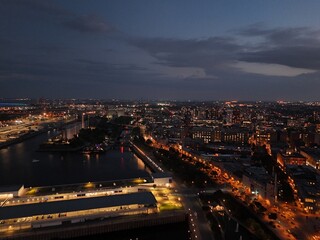 Fototapeta premium Montreal skyline at sunset with Old Port clock tower, marina and city lights reflecting on water. g.