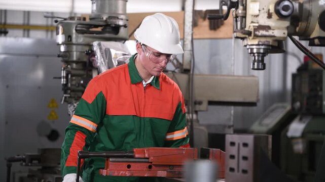 Engineer Industrial work with lathe machine operating in workshop precisely shaping metal workpiece cutting tools rotating spindle controlled movement  accuracy machining and manufacturing processes.