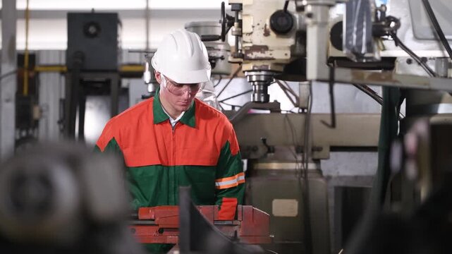 Engineer Industrial work with lathe machine operating in workshop precisely shaping metal workpiece cutting tools rotating spindle controlled movement  accuracy machining and manufacturing processes.