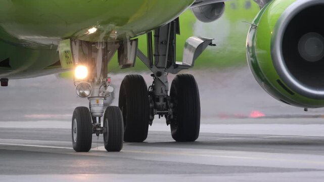 Airplane landing gear runway. Airport terminal maintenance crew aircraft. Preparing for departure takeoff. Safety. Close-up of airplane's wheels before takeoff.