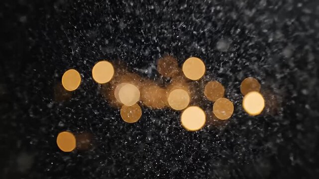 Abstract bokeh lights at night with dark background out of focus blue and white glowing orbs