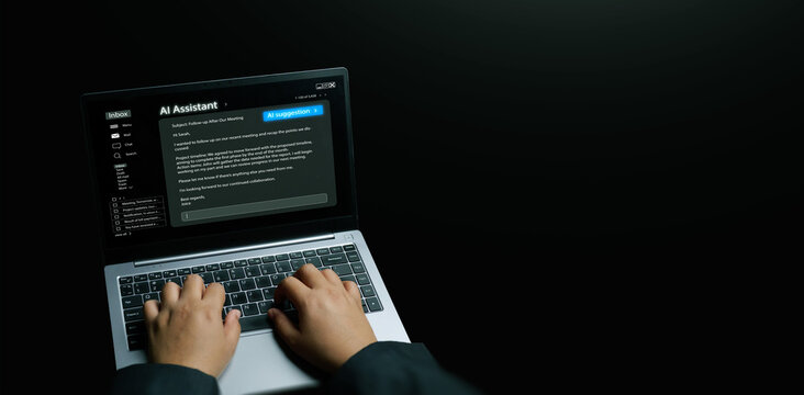 AI assistant concept. Hands using a laptop with an AI suggesting and generating an email reply. Generative artificial intelligence for productivity, large language models, smart personal assistance.