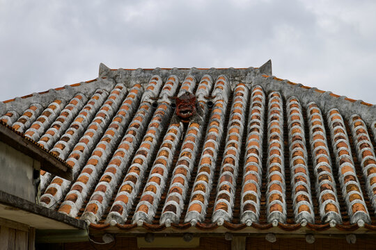 Traditional Shisa guardian statue on a red clay tile roof, Taketomi Island, Okinawa