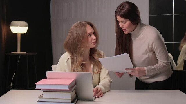 Candidate reviews interview. Job seeker scrutinizes curriculum vitae during interview. Applicant attentively reviews their curriculum vitae during professional interview session