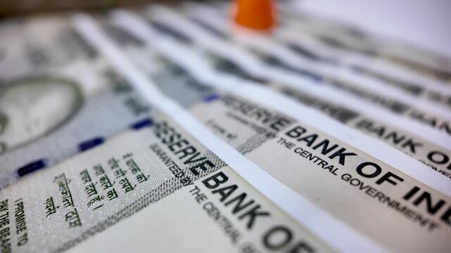 Financial analyst concept with Indian rupee currency banknotes and pawn in the background