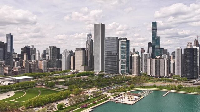 Aerial Timelapse of Downtown Chicago Skyline with Heavy Traffic Flow on Lake Shore Drive at Sunset Over Lake Michigan