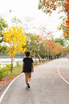 Woman exercise takes a peaceful walk in a park.