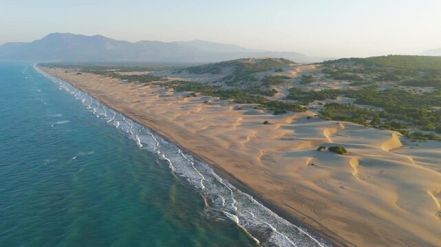 Gelemis, Turkey. Aerial morning view of Patara Beach coastline, Mediterranean Sea waves on golden sand, summer sunrise with soft light. Aerial View, MasterShots, Circle (Far)