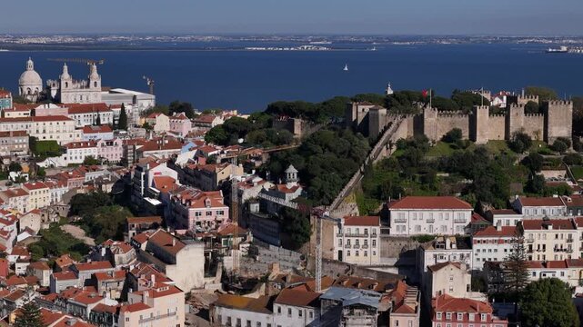 Aerial view of the historic Castelo de Sao Jorge overlooking red-roofed buildings and the Tagus River in Lisbon, Lisbon, Portugal.