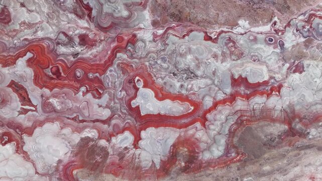 Aerial view of the intricate red and white swirling patterns of the bentonite hills in Hanksville, Utah, United States.