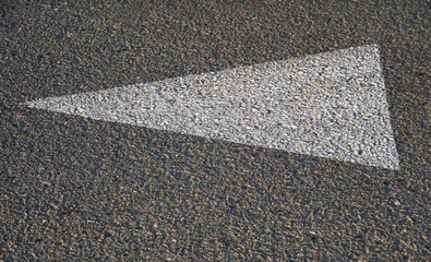 Fototapeta premium Directional arrow on asphalt road with copy space, symbolizing direction and decision