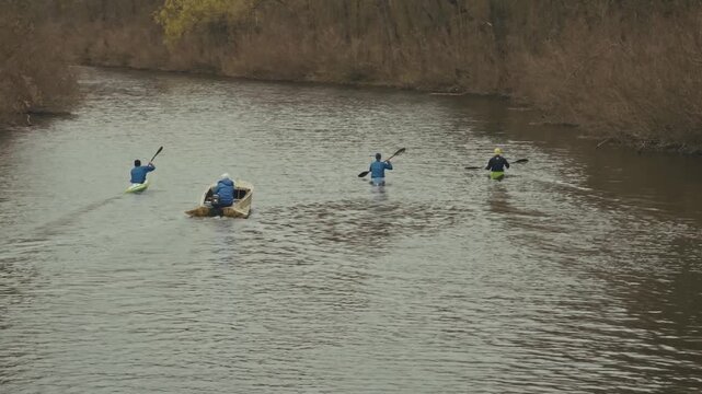 Group Of Athletes Kayaks Together During Water Sports Practice. 
Competitive Rowing Training  In Nature