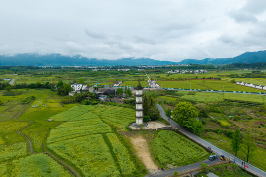 An aerial view shows a tall stone pagoda standing in the middle of green fields in the ancient village of Hongcun located in Yixian County of Anhui Province in rural China
