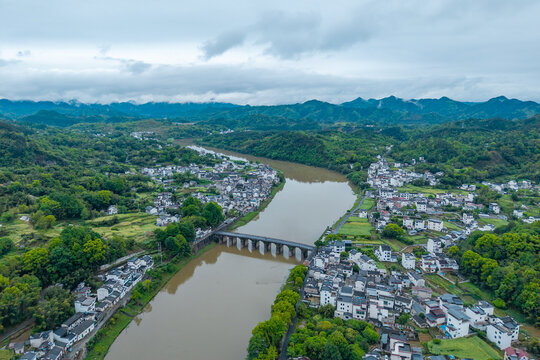 An aerial view shows the traditional village architecture and a historic stone bridge over the river in Huizhou Ancient City located in She County of Anhui Province in China