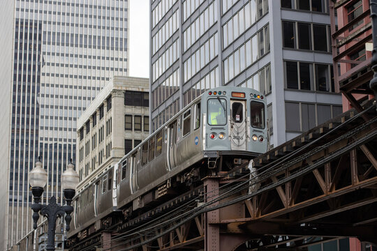 Chicago, IL, USA - Aug 28, 2025: A CTA Orange Line train that offers direct service between Midway International Airport and downtown Chicago travels on an elevated structure in the Chicago Loop.