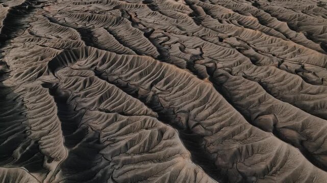 Aerial view of the intricate erosion patterns and ridges of Factory Butte in Wayne County, Utah, United States.