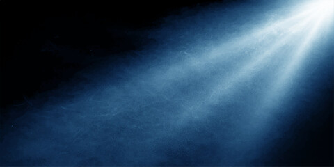 Fototapeta premium A bright blue sky with light rays piercing through dark storm clouds creates a dramatic nature backdrop featuring a misty texture of fog and smoke