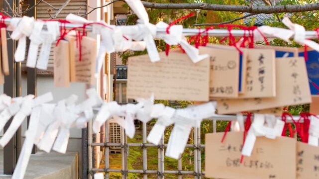 Traditional Ema Wooden Plaques and Omikuji Fortune Papers at Shinto Shrine