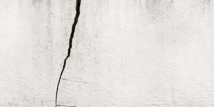 A vintage aged paper texture with a rough grunge pattern overlaid on a blank grey cement wall surface creates an empty textured canvas backdrop for a dirty antique material design